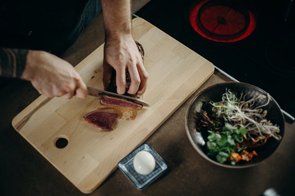 Which type of cutting board is best for meat versus vegetables?